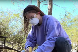 student rebuilding house affected by hurricane