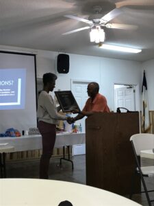 Courtney Woods awards Ellis Tatum the NCEJN Community Resilience Award in 2017 