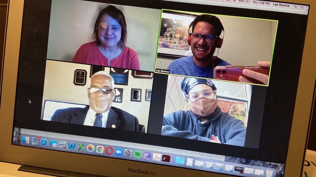 A screenshot of four people on Zoom