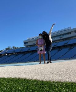 Mentee Lucero stands with mentor Suzy in the Carolina football stadium