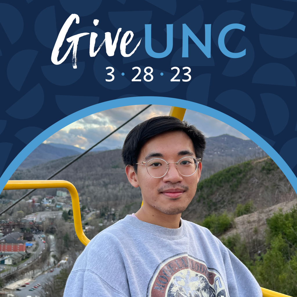 A picture of Alvin on a ski lift with a gray sweater. He has round glasses and short straight black hair. The ski lift is yellow and mountains are behind him. A graphic is above the image that says Give UNC 3 28 23